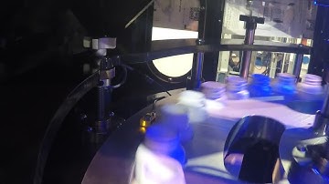 Videojet 7810 UV laser marking on HDPE bottles in rotary transport system