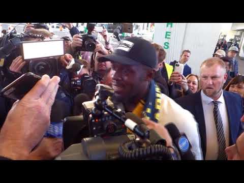 Usain bolt arrives into australia to a media pack ahead of soccer trial