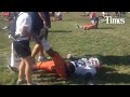 Head football coach Sean Kugler watches as the Miners go through stretching exercises at the start o