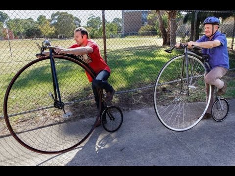 Riding a penny farthing