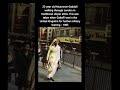 23-year old Muammar Gaddafi walking through London in traditional Libyan attire.