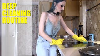 Kitchen cleaning in yellow rubber gloves and blue top