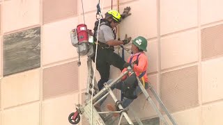 Firefighter rescues construction workers after scaffolding collapses