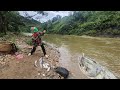 The girl unexpectedly caught a giant fish in the stream on a stormy day.