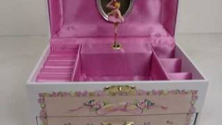 It comes with white background and colorful flowers all-around with ballerina shoes inlay. It also has a drawer on the bottom, for 