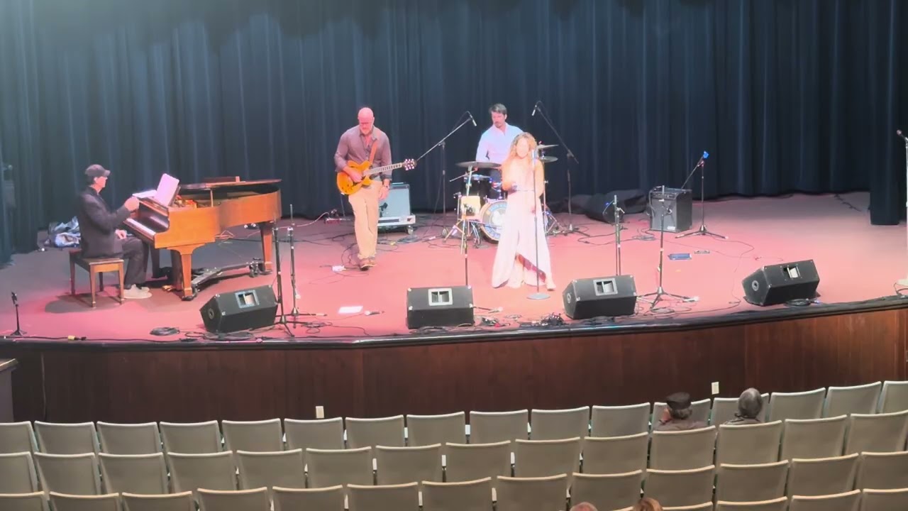 Jazz band performing on a moody nightclub stage under a spotlight