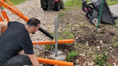 Pulling out old fence posts with an engine hoist.