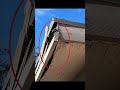Damaged soffit, and fascia at roof corner with severe wood rot, splitting, and exposed structure.