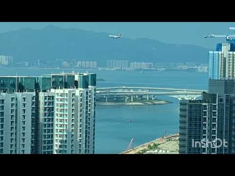 COMMERCIAL AIRCRAFT FAST APPROACHING & LANDING AT HONGKONG INTERNATIONAL AIRPORT