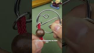 This is a classic IQ test. How can you remove the red string?#puzzle#iq#iqtest