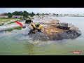 Impressive Skilled Operator Wheel Loader skillfully moves Huge stones towards a deep lake!