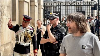 BOSS, SOLDIER & POLICE tell the rude tourists to step back from ARCH, while they crowd the GUARD