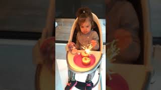 Girl tries to blow out her baby sister's birthday candle/sparkler then falls off bench