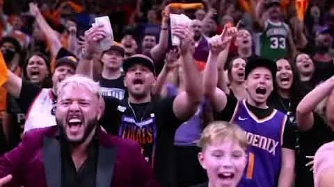Suns fan counts his money while Giannis shoots his free throws