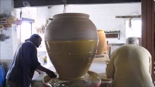 Digby Hoets, South African potter, applying slip to one of his large jars