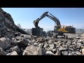 Volvo 530 is back feeding jonsson 1208 jaw crusher doosan 550 wheel loader drive stones in piles