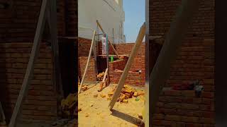 Brick Masonry: The walls are being built using a traditional brick-and-mortar technique. This prov