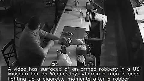 Video: Man lights up cigarette amid armed robbery in US bar
