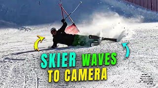 Skier Waves to Camera after Falling Over
