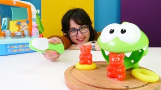 Diş sağlığı videosu. Om Nom oyuncak dişlerini fırçalıyor ve şeker yiyor! Bebek videoları.