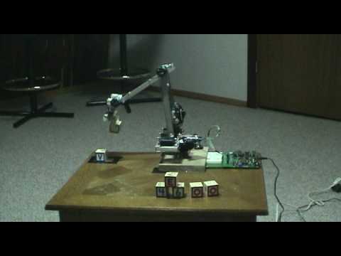 Robotic arm stacking blocks