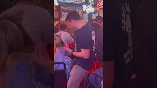 A Man And His Guitar In A Bar