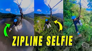 Girl Holding a Selfie Stick Enjoying a Zipline Ride