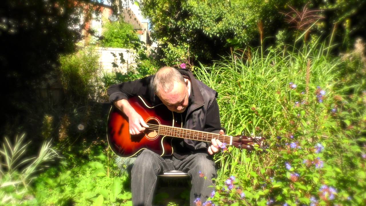 Steve Machin plays guitar in his garden, October 2015.