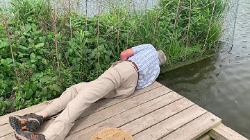 Bruce looks for roots on a BioHaven floating island
