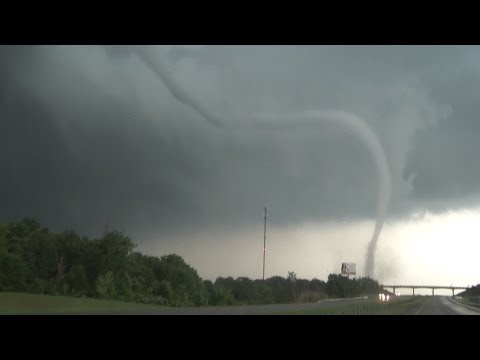 This is video of the Shawnee, Oklahoma tornado crossing Interstate 40 near exit 176 on May 24, 2011. This beautiful tornado hit a semi truck as it crossed the interstate and blew the debris from it into the air. The driver of the semi was ok and only received minor injuries. This tornado was one of many tornadoes during the Oklahoma Tornado Outbreak 2011 on 5/24/2011. You can view my dash cam footage at www.youtube.com I am a storm chaser based in Norman, OK. You can visit my website at www.benholcomb.com for more information about me and full accounts from my past storm chases including video and pictures. ***NOT FOR BROADCAST*** ATTENTION PRODUCERS This media clip is available for license. To license, please contact Ben Holcomb at ben@bholcomb.com or www.benholcomb.com My DVD is for sale! "The First Three Years" a Storm Chasing DVD by myself is available at http Follow me on: Twitter - www.twitter.com Facebook - www.facebook.com