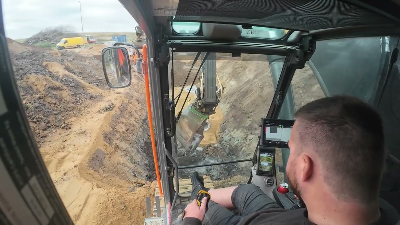 Volvo EC300EL replacing an old concrete pipe with a new line