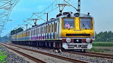Amazing Speedy Aerodynamic advertise Printed EMU Train skip Crowded Level Crossing | Eastern Railway