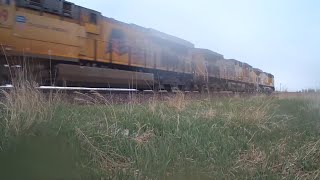 3 UP Locomotives with hopper cars & tanker cars traveling through Elkhart, Iowa