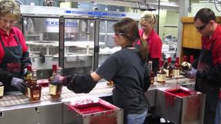 Hand Dipping Bottles at Maker's Mark