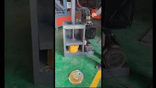 Convenient modern machine pressing used metal barrels for recycling