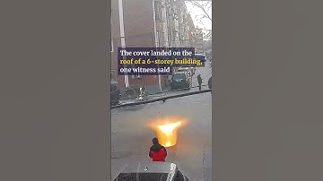 Manhole cover sent flying to building roof after boy sets off firecracker #shorts