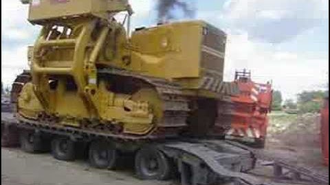 Unloading a Komatsu D355 sideboom.