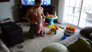 Baby takes 1st steps and father's reaction is priceless.