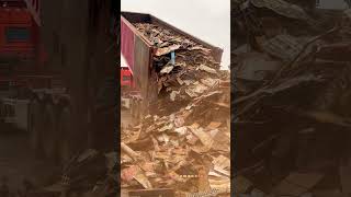 Massive Dump Truck Unloading Tons of Scrap Metal for Recycling