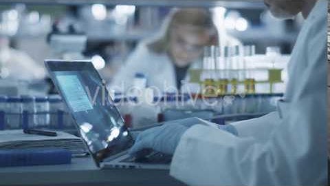 Scientist is Working on a Laptop Computer in a Laboratory - Stock Footage | VideoHive 14135454