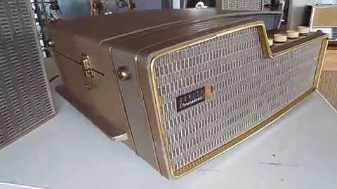 Zenith 5 speaker stereo automatic record player playing a stack of 45