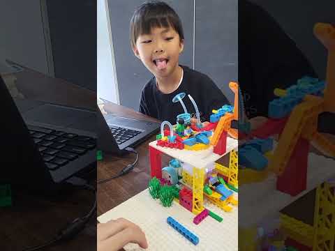 Nate and Winston demonstrating their office and a car that drives out of the garage!