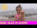 Playing in the ocean with her baby  theplussideofthings