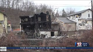 Fire destroys home, damages 2 buildings