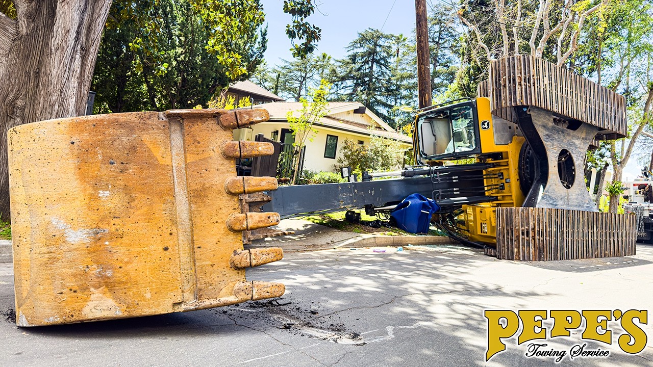 Excavator Rolls Over on Sidewalk, Knocks Down Telephone Pole