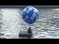 Performance on Moscow rive. Parting with sanctions brands. Text on ballon “Goodbye!”