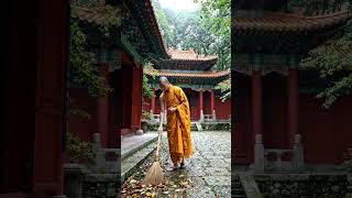 a monk cleaning temple