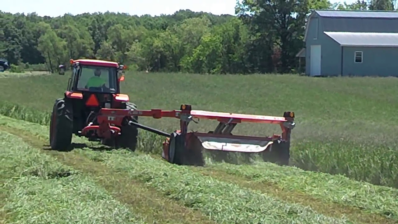 Kubota mowing hay