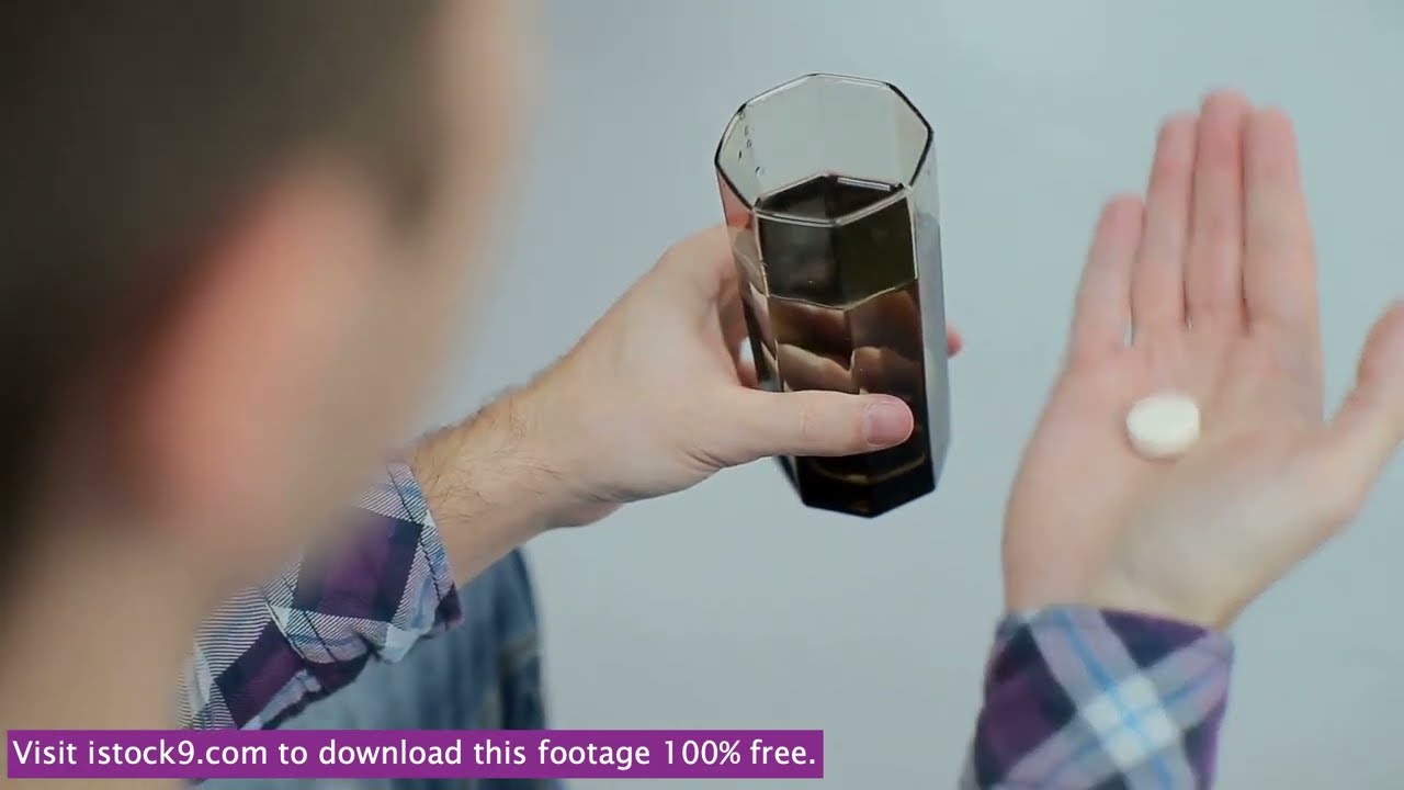 A person taking the medication pill with water stock video footage
