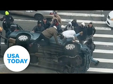 Good Samaritans New York City rush to help stuck driver flipped car | USA TODAY